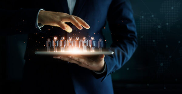 Hand hovers over figures