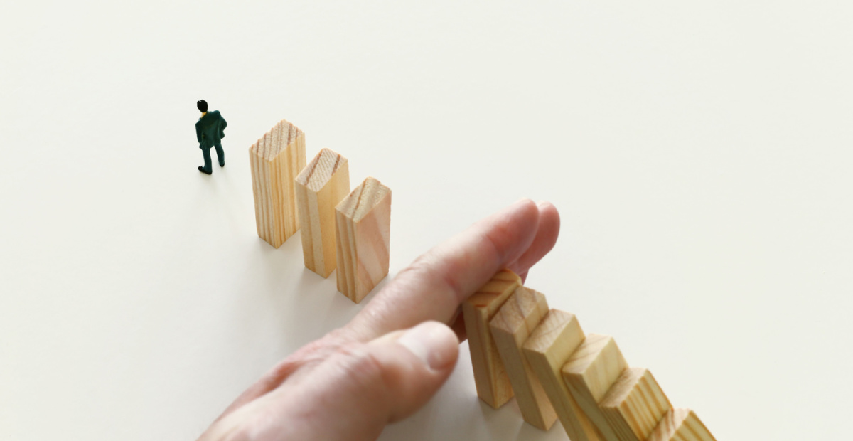 Hand holds back dominoes