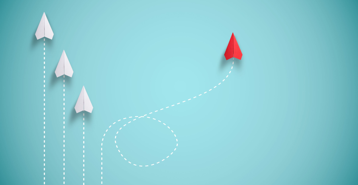 Red paper plane reverses then rejoins
