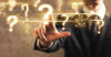 Man's finger on question mark