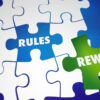 Puzzle pieces with open space for rules and green piece for rewrite