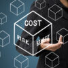 Woman pointing to cube with Cost, Risk and Benefit written