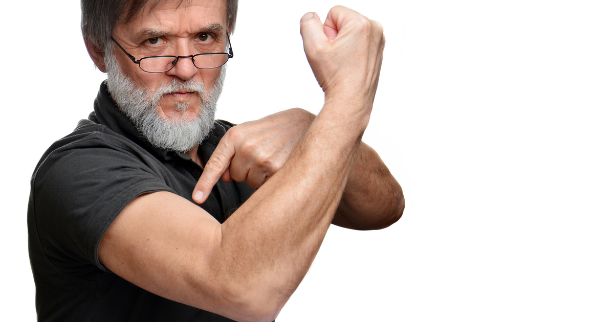 Old man pointing to muscle